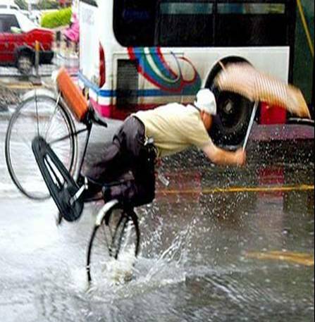 Picture:  A bike rider goes over the handle bars in China.  No helmet in use.